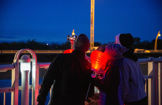 Un groupe de personnes avec des lanternes Illumine la nuit prenant une photo