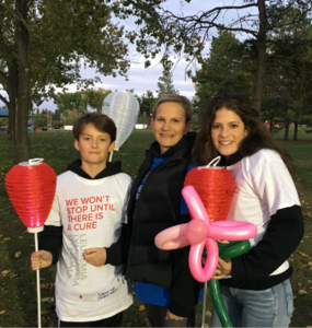 Three people in a wooded area